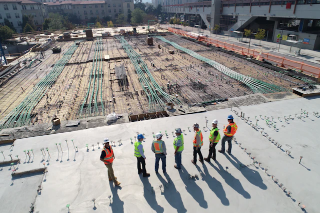 Construction crew overlooking an active build site